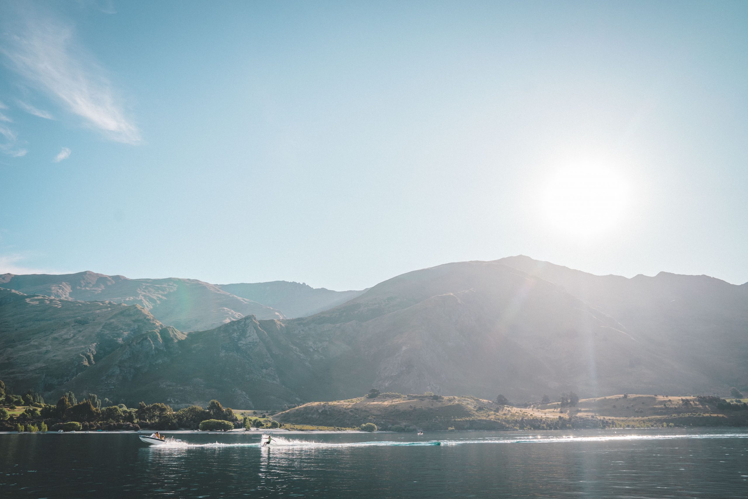 A boat tows a skier on Lake Wanaka in New Zealand
