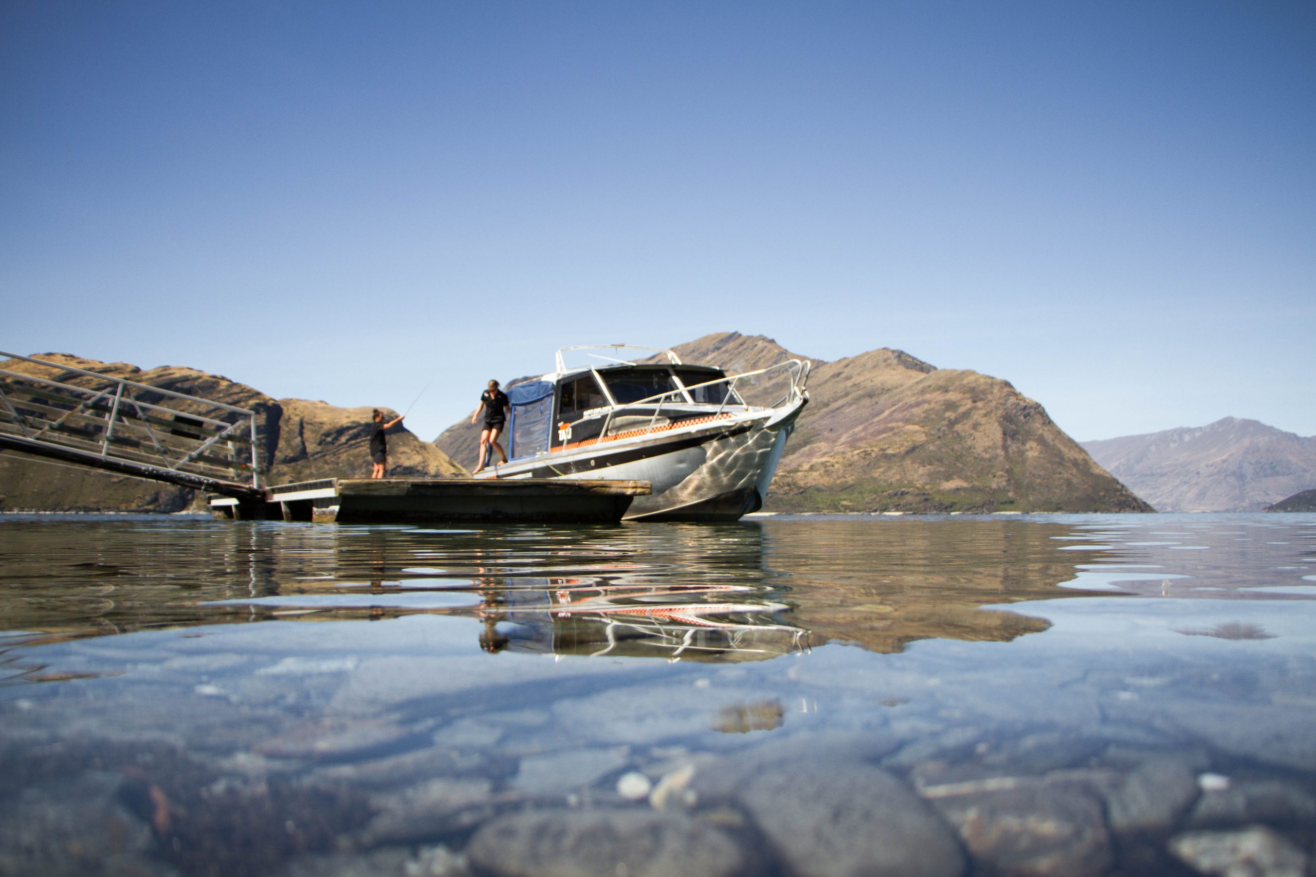 A boat is docked a Mou Waho Island in Wanaka, New Zealand
